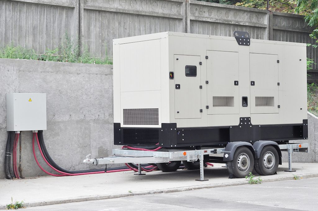 Industrial Diesel Generator. Standby generator. Industrial Diesel Generator for Office Building connected to the Control Panel with Cable Wire. Backup Generator Power.
