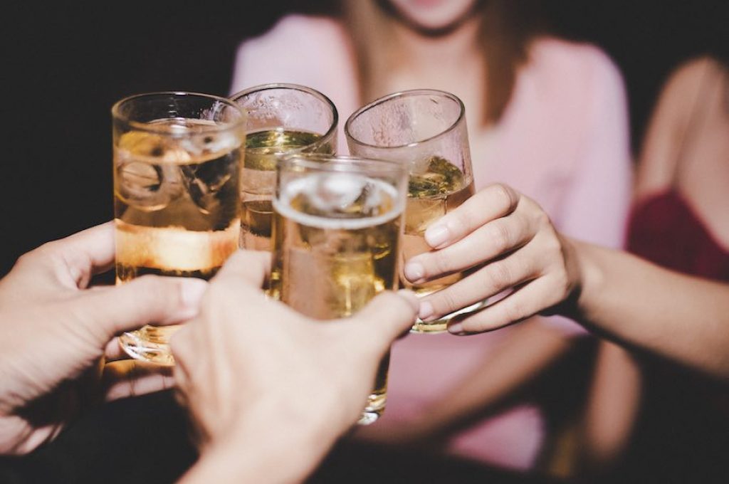Female Friends with glass beer At Party
