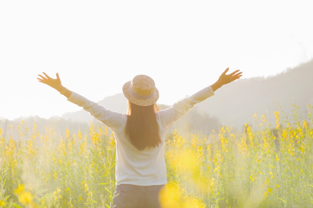 Female teen girl stand feel freedom and relaxation travel outdoor enjoying nature with sunrise.
