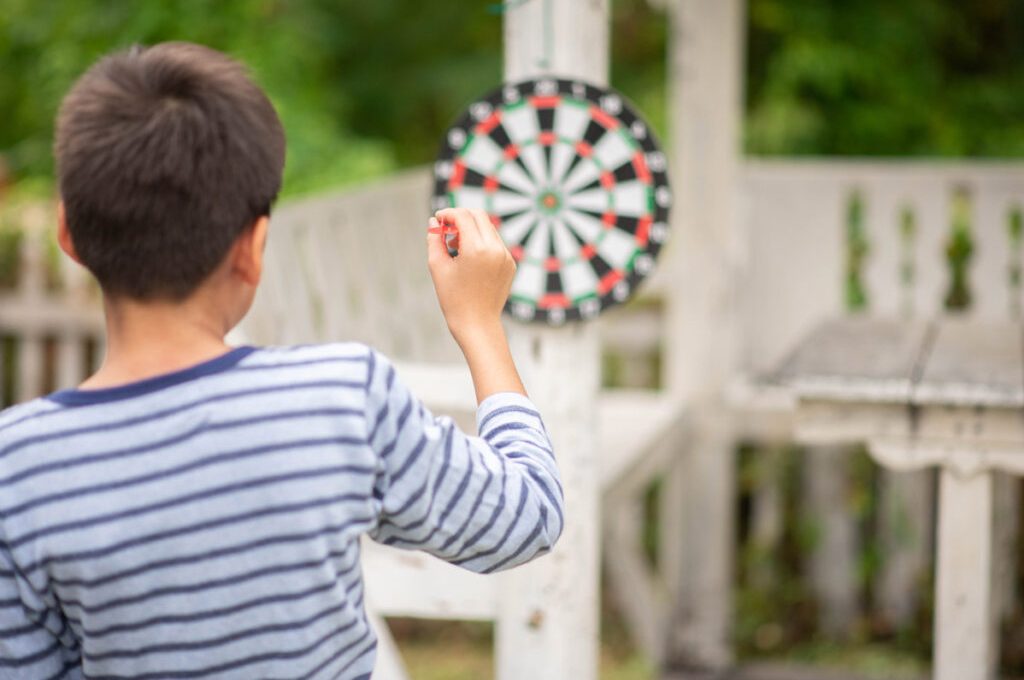 little-boy-playing-darts-board-family-outdoor-activity-1024x684