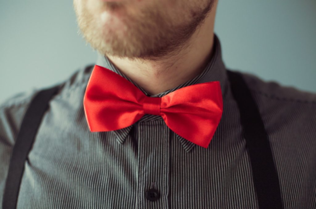 Bearded face and a red bowtie on the shirt